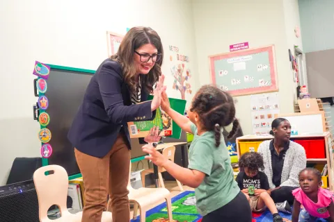 Elfreth high fives child
